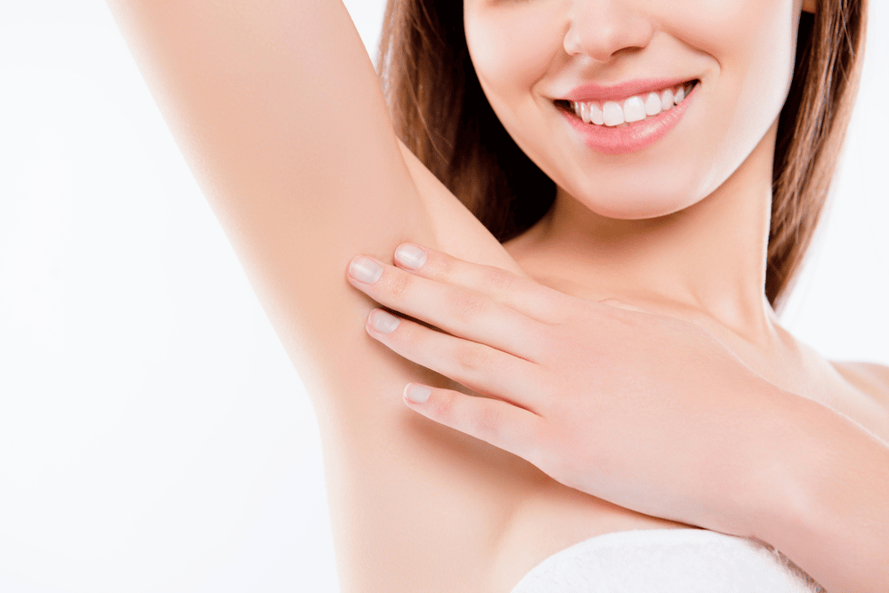 female laser hair removal model holding her arm up